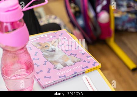 Kyiv, Ukraine - March 20, 2026: Corgi puppy themed stationery and a reusable beverage container rest on a desk surface to convey a cheerful learning e Stock Photo