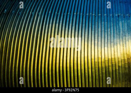 close-up of blue-toned metal bars with brushed surfaces, repeating parallel ridges and strong diagonal perspective Stock Photo