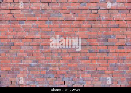 Red brick wall in classic running bond pattern, filling the frame as a background texture Stock Photo