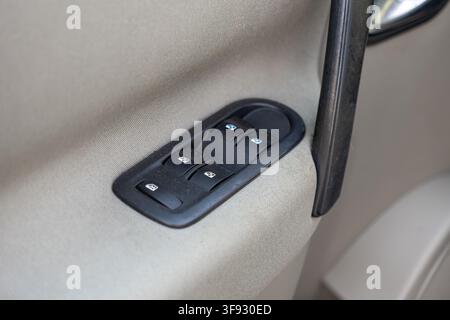 Close-up shot of car door electric window switches with simple icon symbols, showcasing accessible automotive control mechanisms used for everyday veh Stock Photo