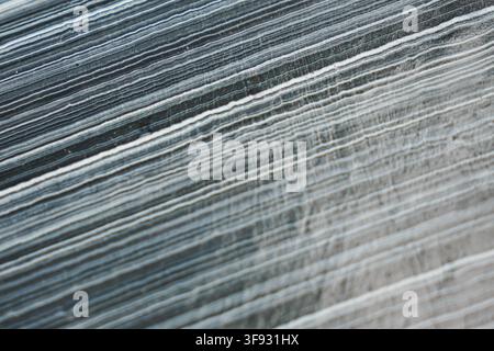 Close up of layered surface texture with diagonal lines in shades of gray and blue showing natural pattern and detail. Stock Photo
