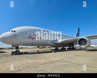 Airbus A380 prototype MSN001 with 'iflyA380.com' livery parked on the tarmac under a clear blue sky. Stock Photo