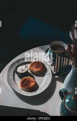 Hotel Breakfast with Coffee and Pastries on Dark Table Stock Photo