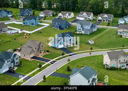 Low-density two story private homes with large lot size and green grassy lawns in summer season. Rural residential suburbs with upscale suburban house Stock Photo