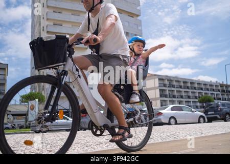 Cyclist Locking His Bicycle to a Metal Railing for Security Stock Photo