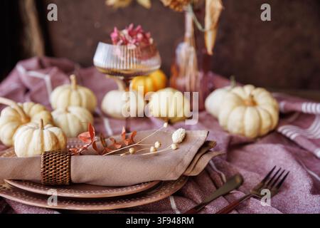 Rustic autumn table setting with pumpkins and elegant tableware Stock Photo