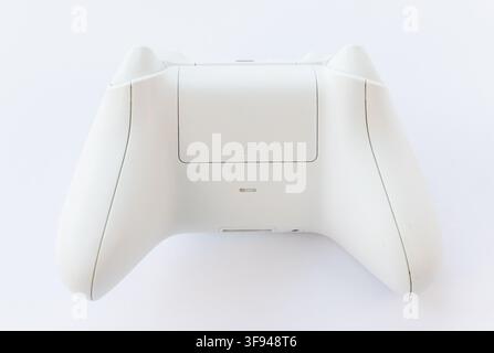 A white wireless gaming controllers back is shown on a white background Stock Photo