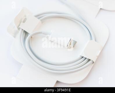 A new white USBC cable is neatly coiled in its packaging Stock Photo