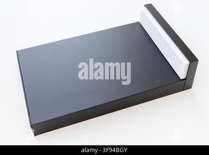 A sleek black rectangular object with a white accent on a plain white background Stock Photo