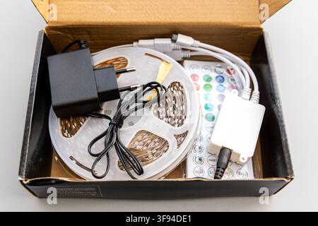 An LED strip light kit with accessories is shown inside a box Stock Photo