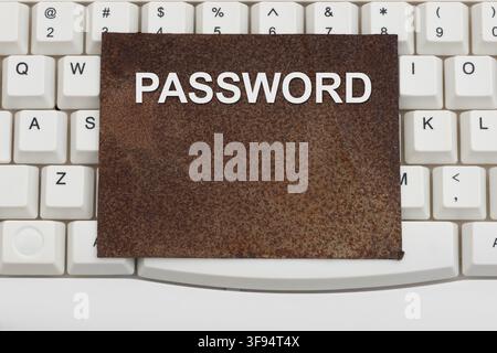 Password text rusty sign on a white computer keyboard for old and weak authentication Stock Photo
