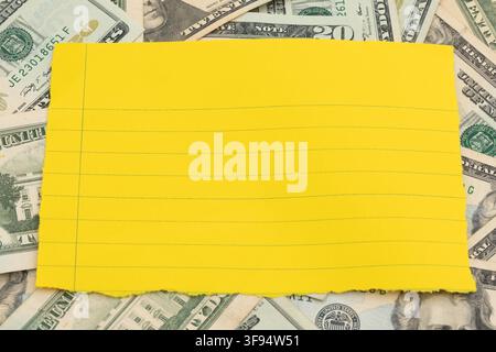 Blank lined paper on twenty dollar bills for personal budget planning Stock Photo
