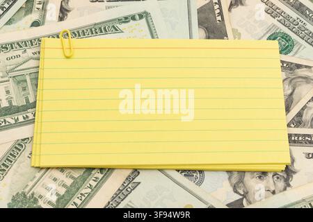 Blank lined index cards on twenty dollar bills for personal budget planning Stock Photo