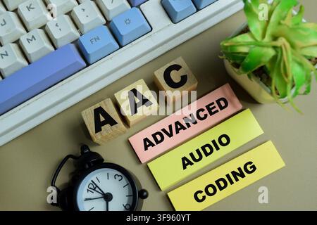 Concept of AAC - Advanced Audio Coding write on sticky notes isolated on Wooden Table. Stock Photo