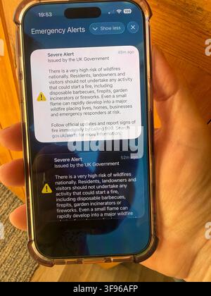 Smartphone screen showing Emergencyy Allert issued by the UK Government for high risk of drought during the summer drought and heatwaves of 2026 Stock Photo