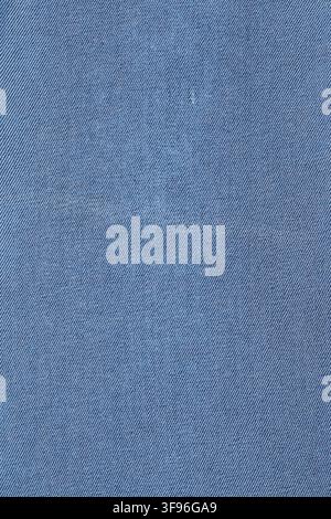 Blue denim fabric texture close up view. Natural cotton material for clothing garment construction. Industrial textile pattern for fashion design and Stock Photo