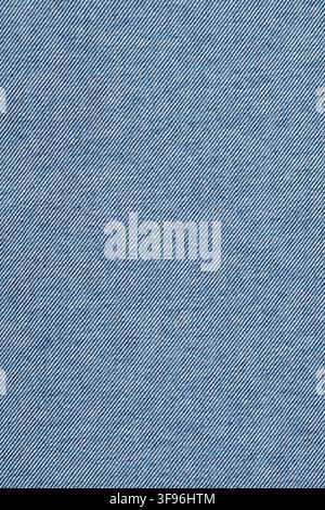 Blue denim fabric texture with diagonal weave pattern. Close-up of durable cotton material. Abstract textile background for fashion design, garment in Stock Photo