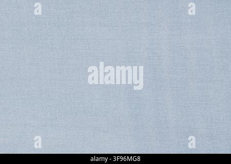 Denim fabric background. Light blue cotton textile texture for fashion industry. Casual clothing material pattern closeup. Durable woven canvas surfac Stock Photo