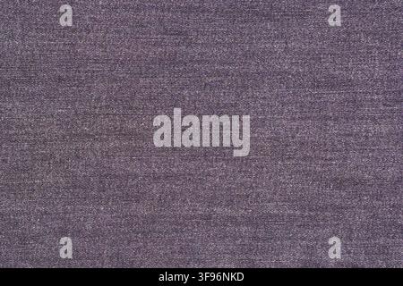 Dark purple denim fabric texture background. Close up of cotton jeans material. Textile surface pattern for fashion design, clothing industry, creativ Stock Photo