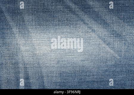 Blue denim fabric texture with worn pattern. Grunge textile surface background showing cotton weaves detail. Casual clothing material design element f Stock Photo