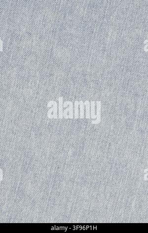 Light blue denim fabric texture. Close up view of classic stone washed jeans material. Durable woven cotton cloth background for fashion design, texti Stock Photo