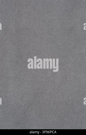 Gray denim fabric background with textured pattern. Close up view of cotton material surface. Clothing textile detail for fashion industry usage or ca Stock Photo