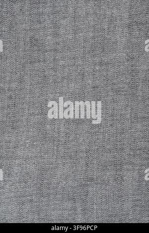 Close-up texture of high quality black denim jeans fabric. Durable cotton material with twill weave pattern. Abstract textile background for fashion i Stock Photo
