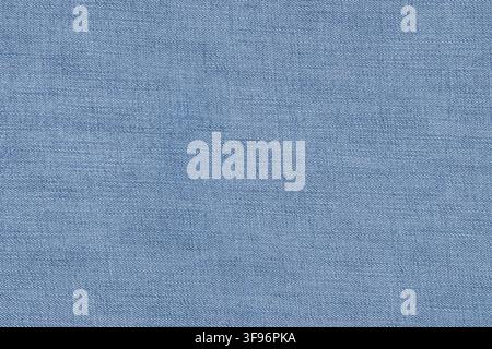 Blue denim jeans fabric texture close up. Woven cotton textile surface as empty background. Material pattern of classic casual clothes. Detailed macro Stock Photo