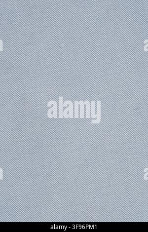 Light blue denim fabric texture close up. Minimalist textile background made of cotton. Clothing material pattern for apparel design. Soft woven surfa Stock Photo