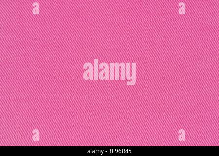 Pink fabric texture with diagonal weave pattern. Macro view of cotton textile material. Close up background for creative design projects and graphic o Stock Photo