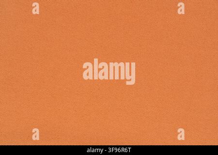 Orange fabric texture with clear diagonal woven pattern. Cotton textile background material for clothing design and construction. Natural material sur Stock Photo