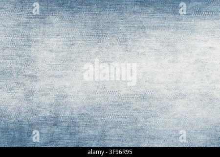 Blue denim fabric texture background. Distressed jeans material with light wash and vintage effect. Durable textile surface for fashion design, appare Stock Photo