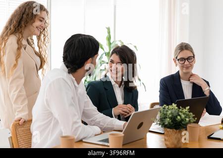 Diverse business team collaborating and discussing in office meeting Stock Photo