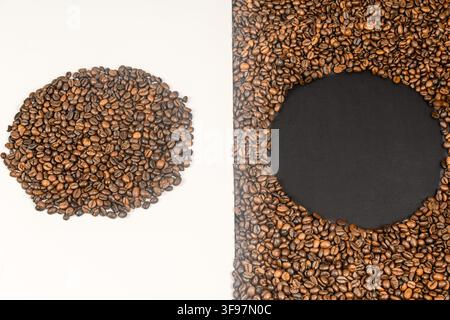 Conceptual top view of roasted coffee beans forming a solid circle on white and a circular frame with central copy space on black. Stock Photo