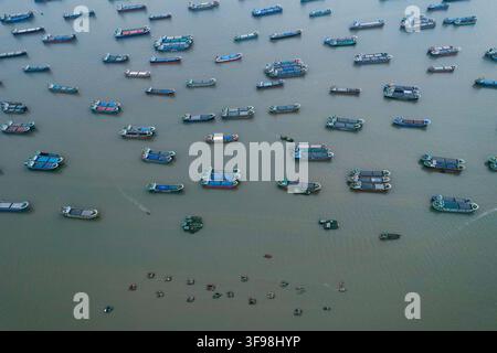 Aerial view of a busy shipyard with numerous cargo ships and boats ...