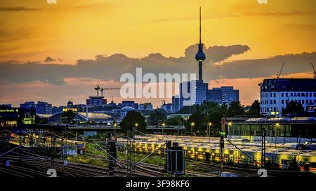 Sunset over train tracks and parked trains, Berlin with the distinctive television tower and urban skyline in the background, Berlin Stock Photo
