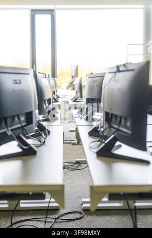 Set of computers on desks in a modern office Stock Photo