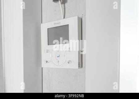 White thermostat on white wall, modern design, minimalist environment, parking garage construction, Calw, Germany Stock Photo