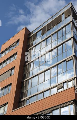Office glass building facade and reflections as seen from below on sunny day Stock Photo