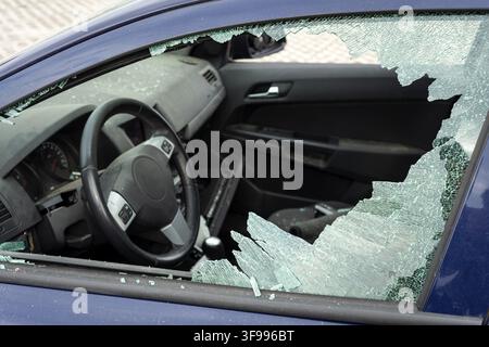 Vandalised car with a smashed broken side window Stock Photo