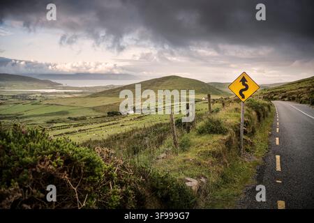 curvy road sign at Connor Pass, Dingle Peninsula, County Kerry, Ireland, Wild Atlantic Way, Europe Stock Photo