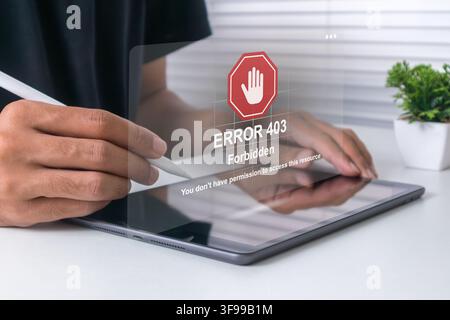 A man using a tablet computer with Error 403 message on screen. Error 403 Forbidden. Stock Photo