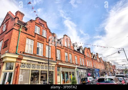 Ornate Victorian red-brick commercial buildings line Peascod Street in the historic centre of Windsor. Stock Photo