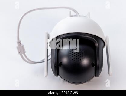 A white and black wireless security camera is shown on a white background Stock Photo
