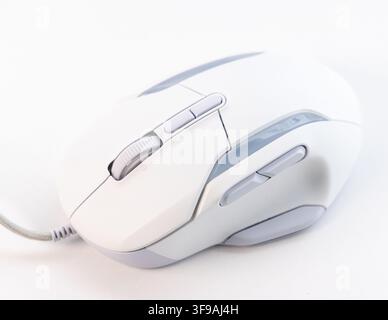 A white and grey wired computer mouse rests on a plain surface Stock Photo