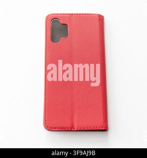 A red textured smartphone case lies flat on a white background Stock Photo