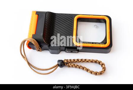 A black and orange waterproof phone case with a braided strap Stock Photo