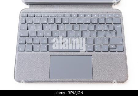 A grey fabric keyboard with a trackpad sits on white Stock Photo
