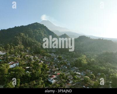 Aerial view of Kaliurang in the lush mountainous landscape with dense ...