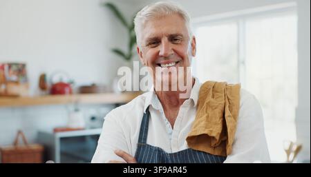 Cooking, portrait or senior man in kitchen with smile, good mood or meal prep in retirement hobby. Happy, apron and elderly person with confidence Stock Photo